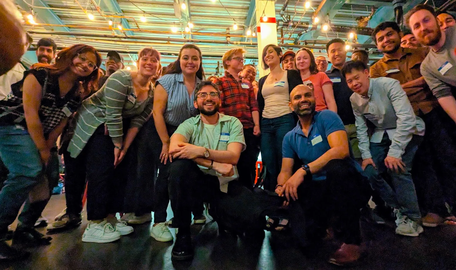 People at tables engaged in conversation at a Boston Conversations event
